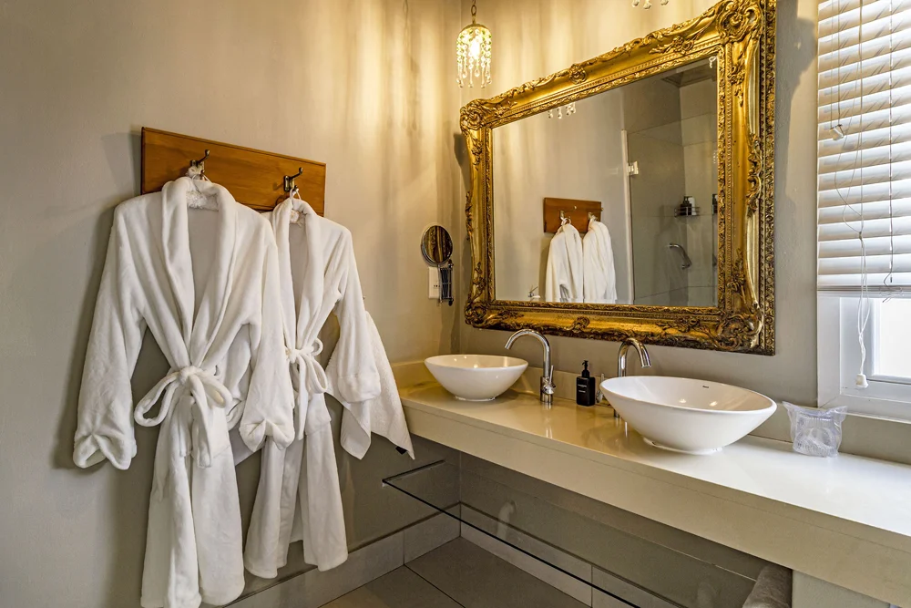 _MG_0006 Bathrobes beside twin vessel basins and a gilt mirror