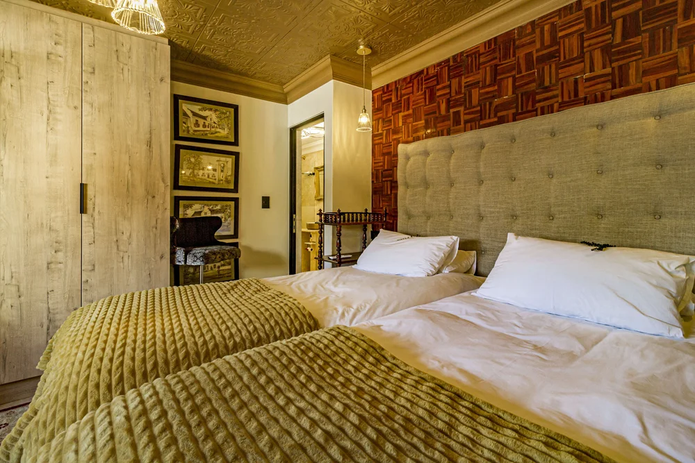 _MG_9903 Twin beds with mustard throws and an upholstered headboard