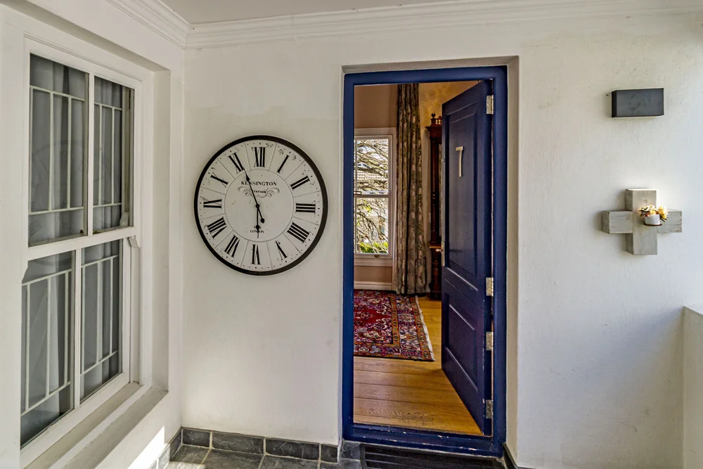 _MG_9967 Blue-painted doorway and wall clock in the Superior Double Room
