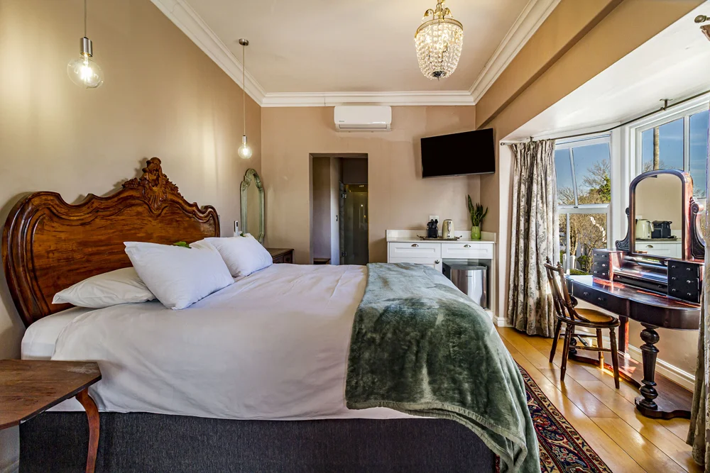 _MG_9978 Double bed with a carved wooden headboard and green throw