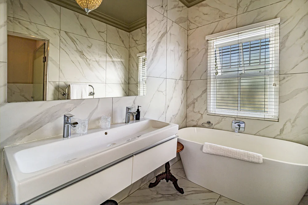 _MG_9991 Marble-look bathroom with a double basin and freestanding bath