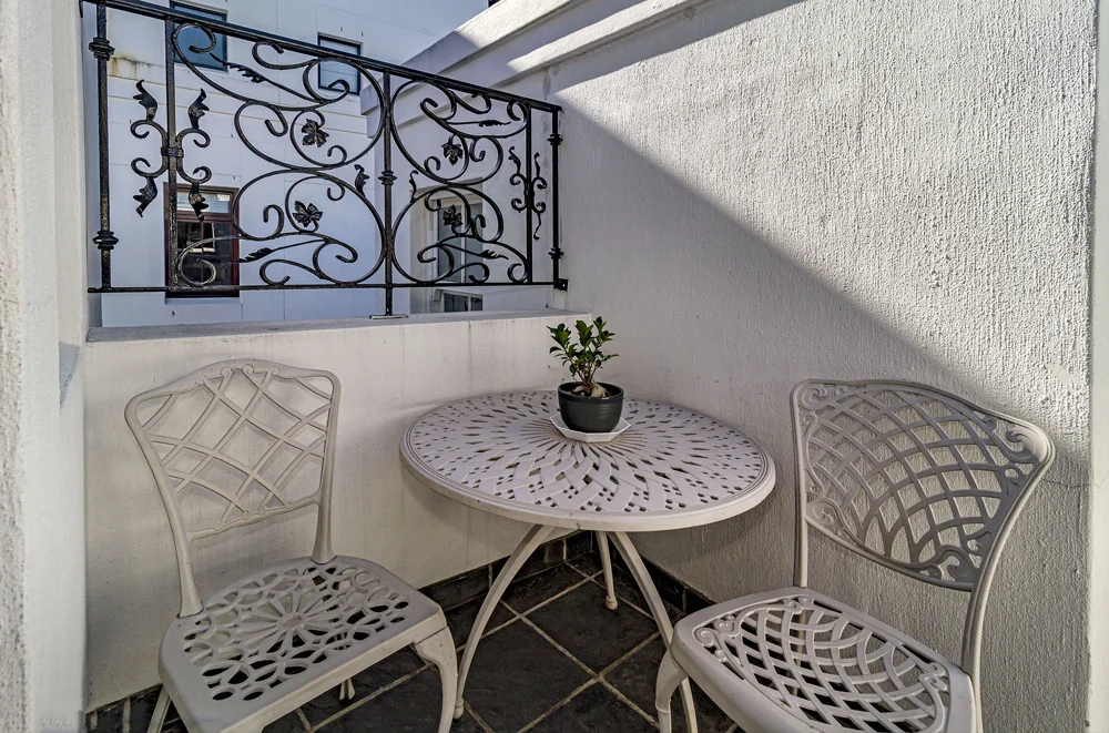 _MG_9995 Balcony with a white wrought-iron bistro table and chairs