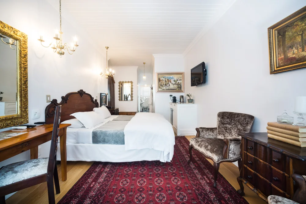 peartree_batavia-60 Luxury Twin Room with a carved headboard and armchair